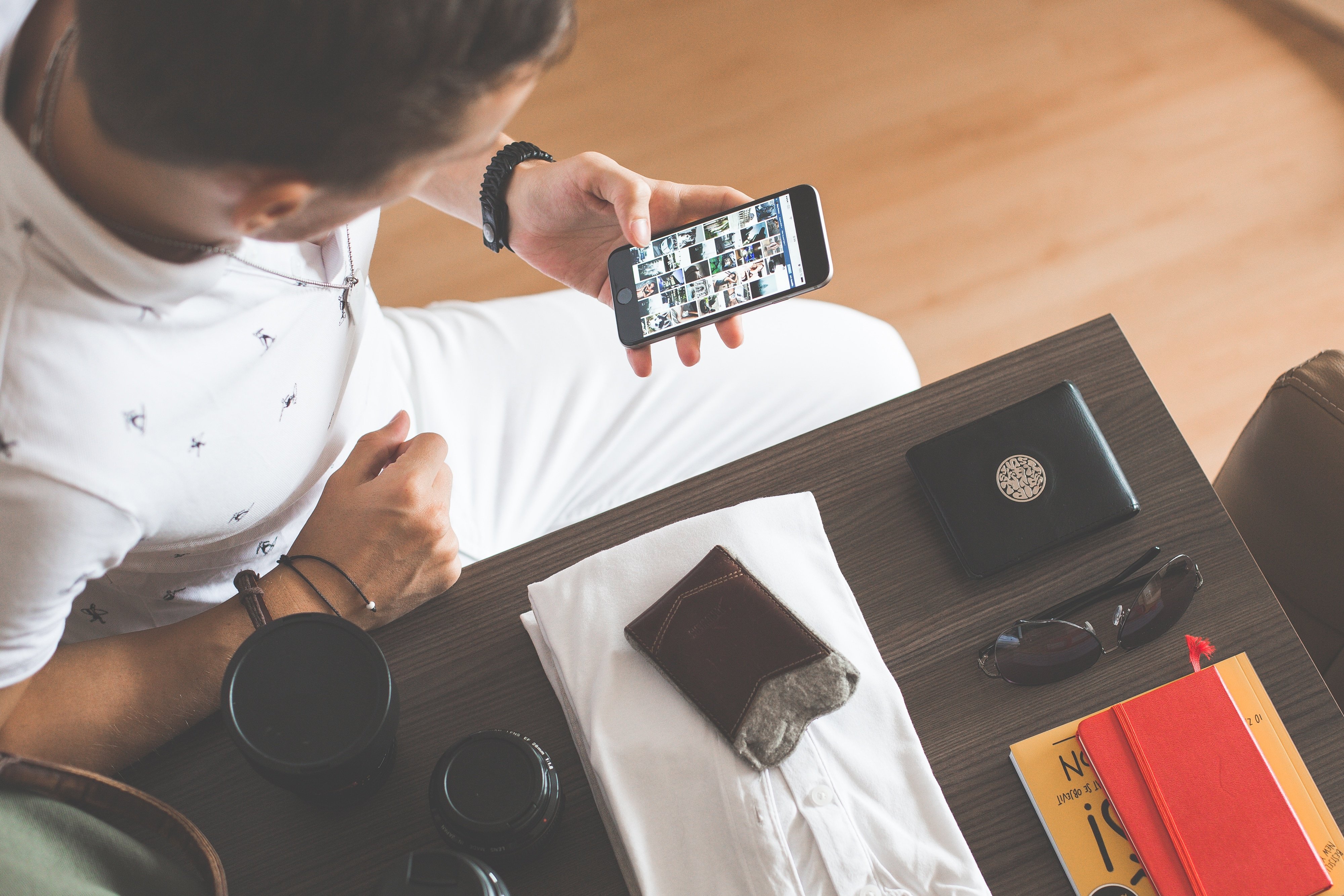 man-browsing-on-his-phone-while-packing-picjumbo-com man-browsing-on-his-phone-while-packing-picjumbo-com
